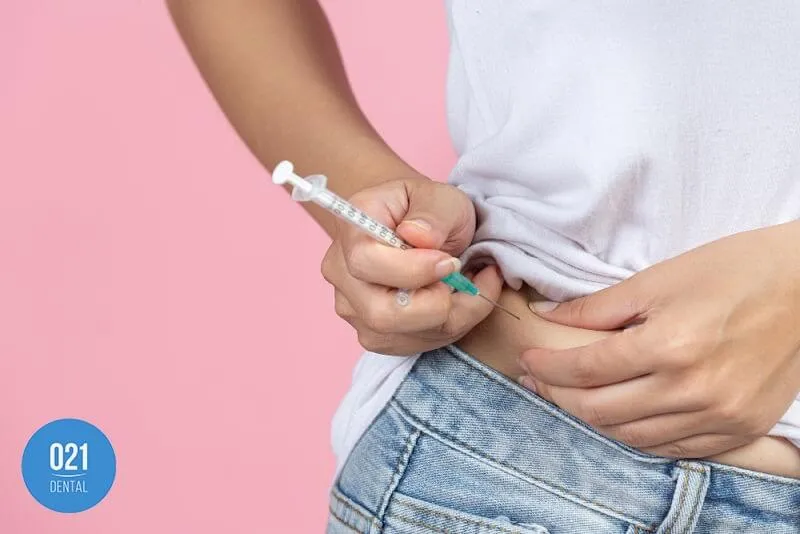 Imagem de uma pessoa aplicando uma injeção de insulina